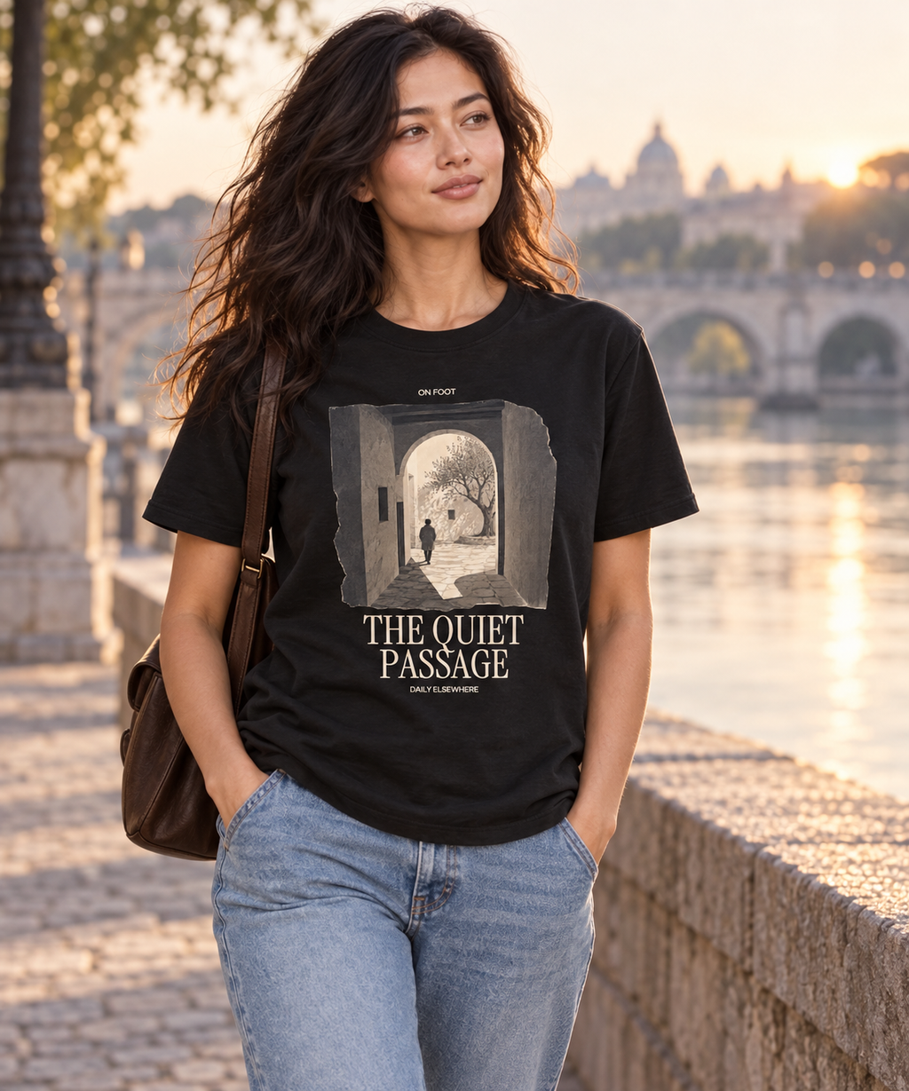 Woman wearing a dark T-shirt with the The Quiet Passage front print.