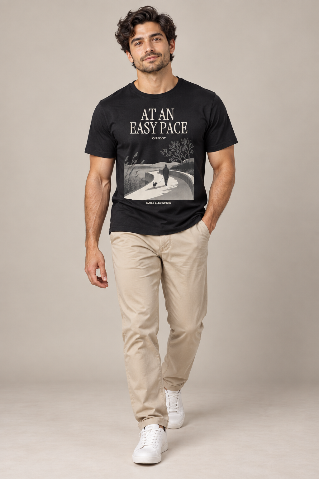 At An Easy Pace — Male model wearing a dark T-shirt with light front artwork. Daily Elsewhere.