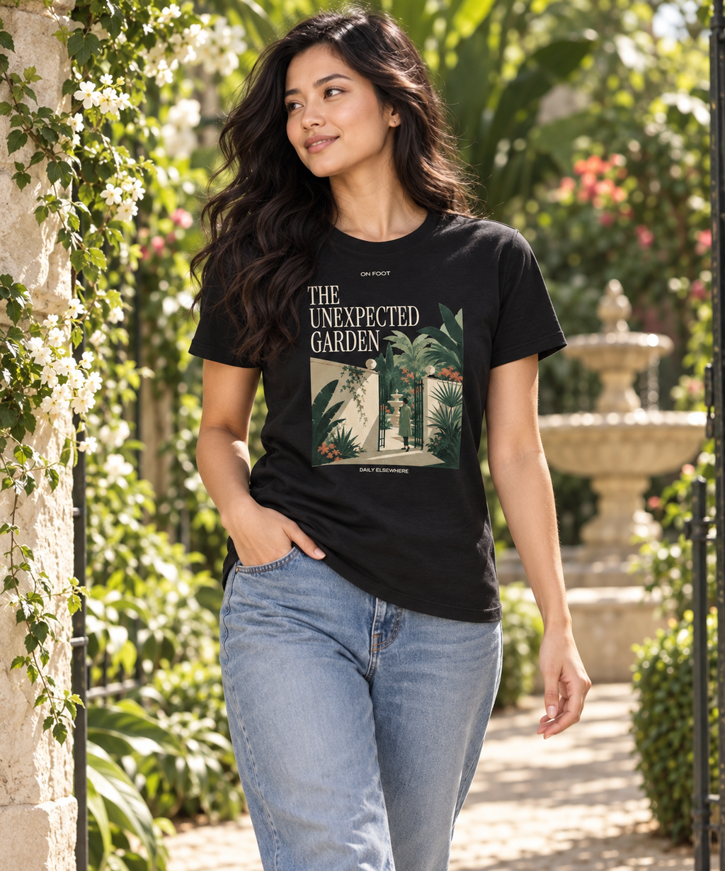 The Unexpected Garden — Male model wearing a dark T-shirt with light front artwork. Daily Elsewhere.