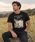 Just Being Here — Female model wearing a dark T-shirt with light front artwork. Daily Elsewhere.