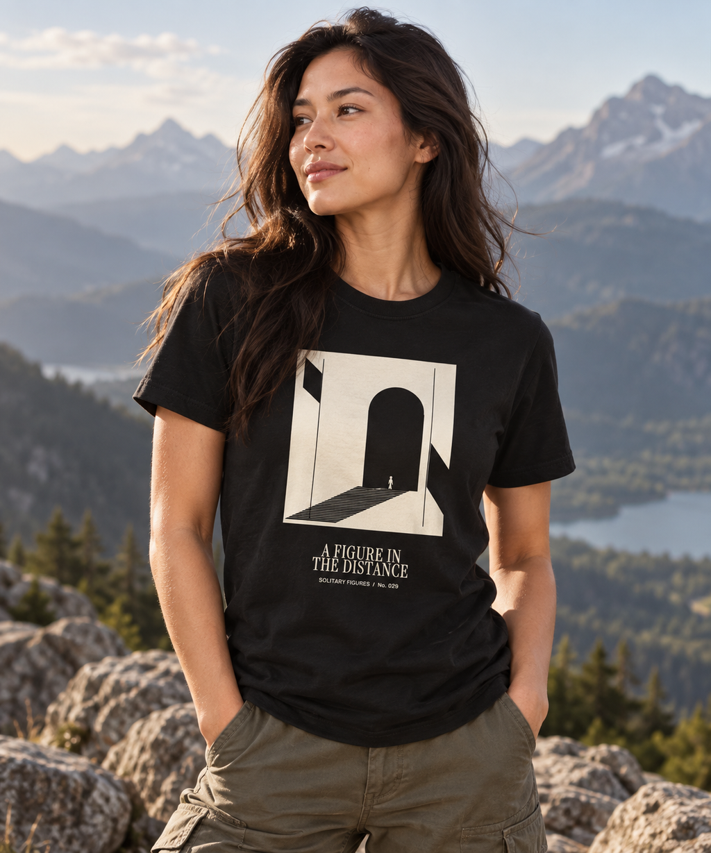 A Figure in the Distance — Dark T-shirt with light front artwork on a contextual background. Daily Elsewhere.