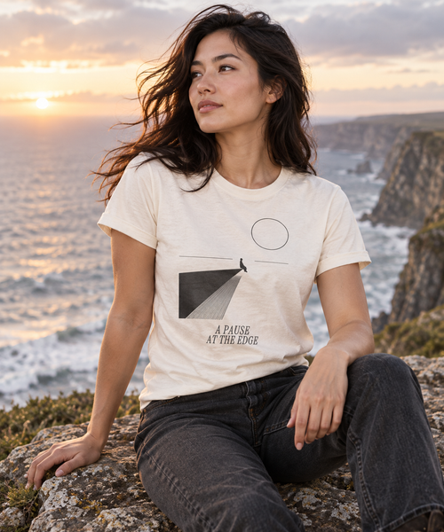 A Pause at the Edge — Male model wearing a light T-shirt with the front artwork. Daily Elsewhere.