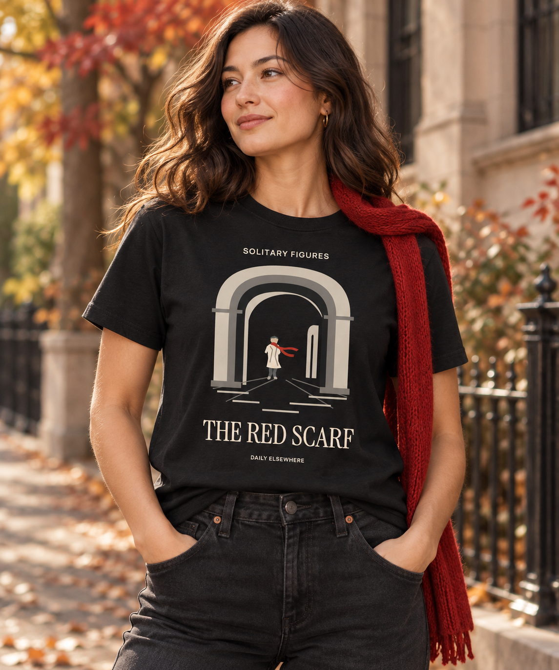 The Red Scarf — Male model wearing a dark T-shirt with light front artwork. Daily Elsewhere.