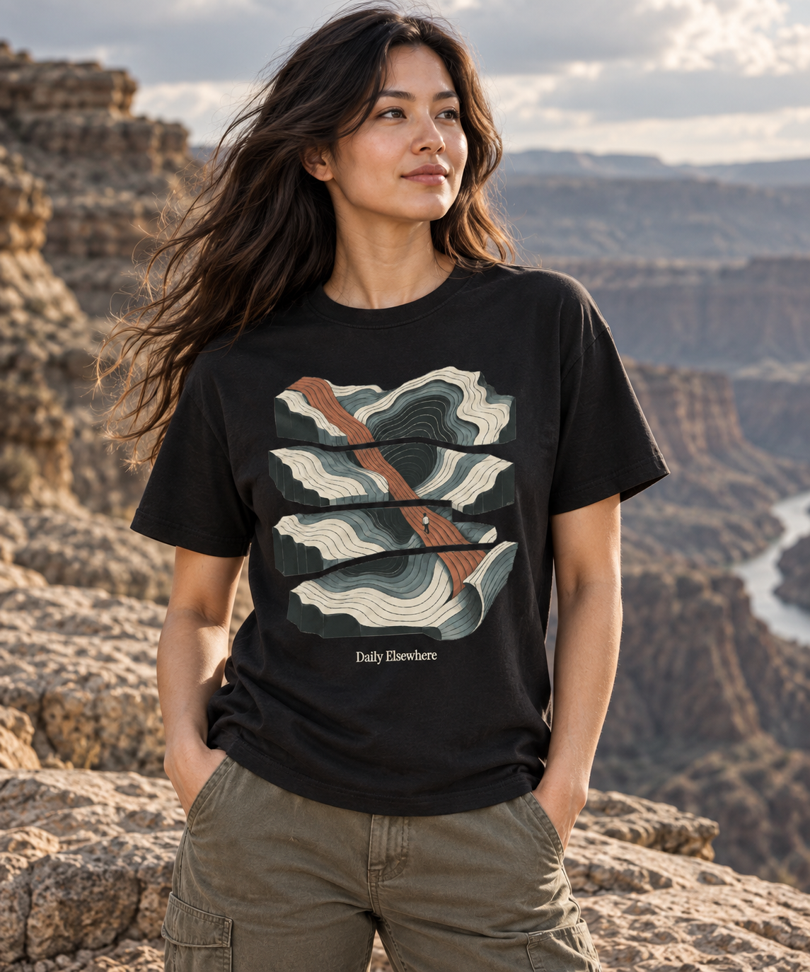 Fault Line — Female model wearing a dark T-shirt with light front artwork. Daily Elsewhere.
