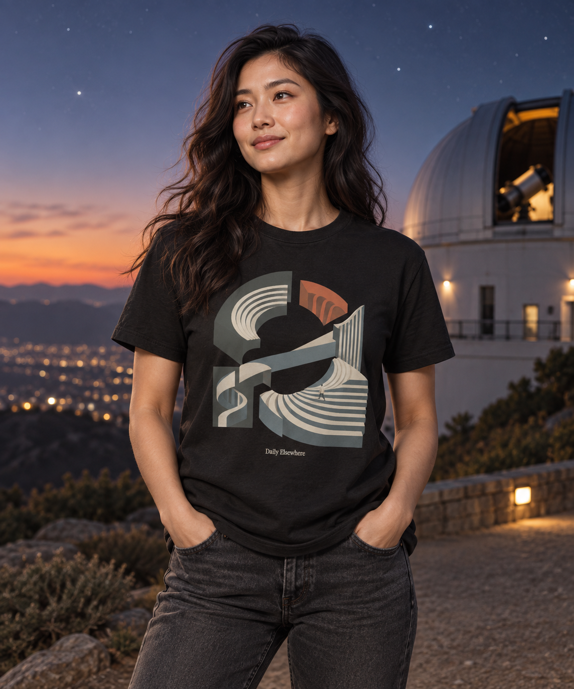Unfixed Orbit — Female model wearing a dark T-shirt with light front artwork. Daily Elsewhere.