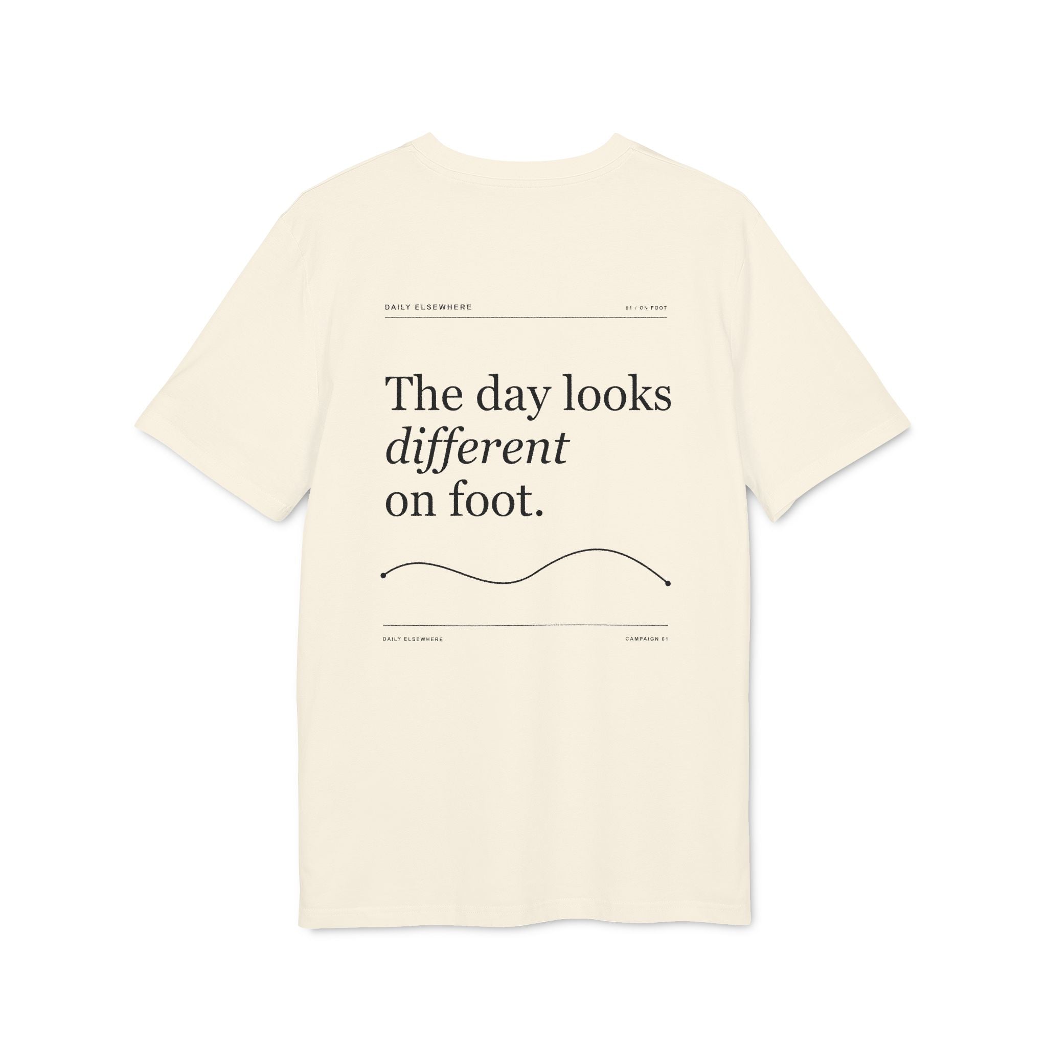 Back of a Natural Raw organic-cotton T-shirt with “The day looks different on foot” graphic.
