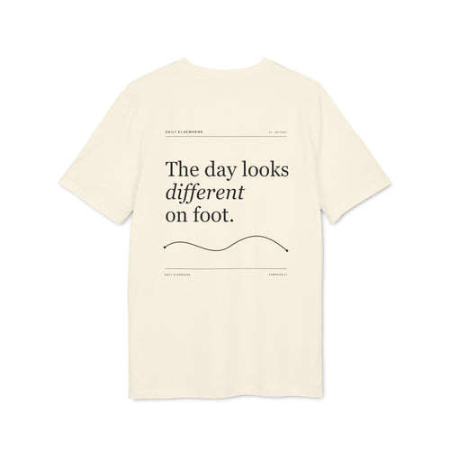 Back of a Natural Raw organic-cotton T-shirt with “The day looks different on foot” graphic.